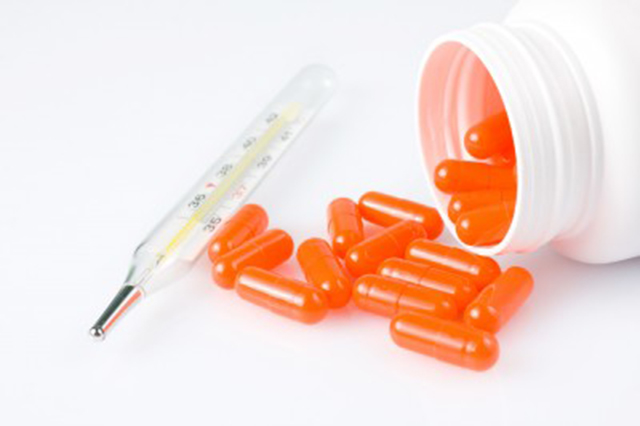 Image of orange capsules spilling out