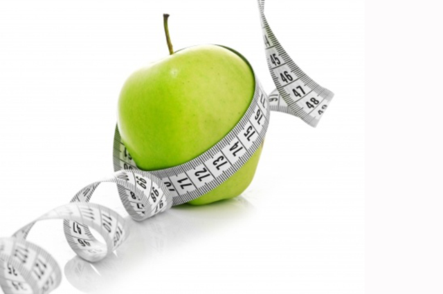 green apple with tape measure
