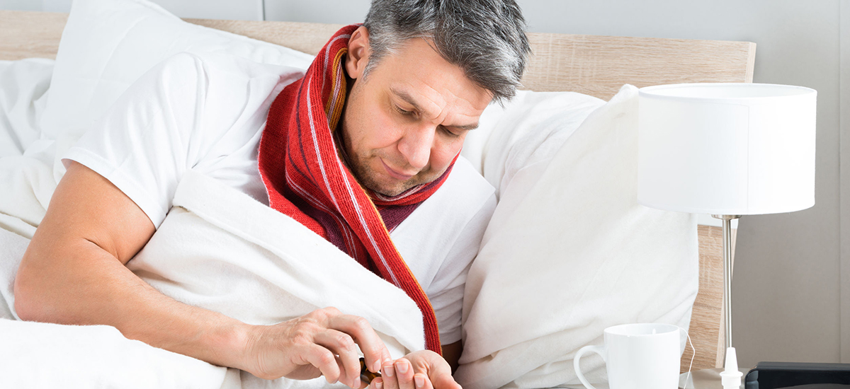 Slide Image of a man in bed using a smart phone