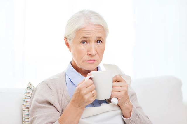 Image of older lady drinking from mug. Block on Access to medicaation for patients with symptoms of Covid nineteen.
